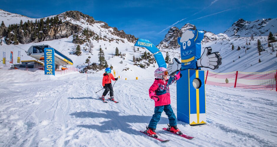 Two kids skiing under blue sky on the Funslope Hauser Kaibling. | © Hauser-Kaibling
