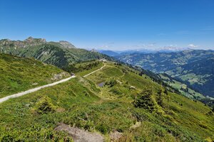 Panorama-Wanderweg über grüne Bergrücken mit Blick ins Tal, bei klarem Himmel entlang der Himmelsroute am Kieserl. | © TVB Großarltal