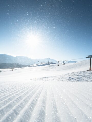 Eine perfekt präparierte Skipiste glitzert in der Morgensonne. | © Ski amadé